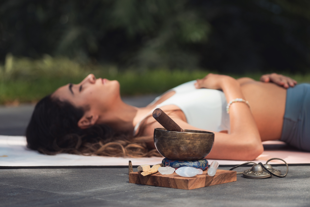 Woman Lying on Blue Yoga Mat